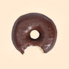 Chocolate donut on yellow background