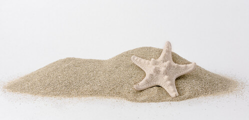 Holidays and sand beach. Close up of a starfish on the hipe of sand