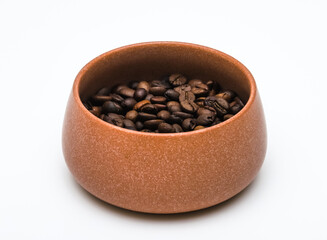 Coffee beans in a cup on a table on a white background. Shallow depth of field