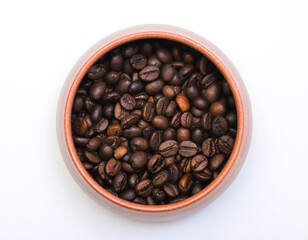 Coffee beans in a cup on a table on a white background. Shallow depth of field