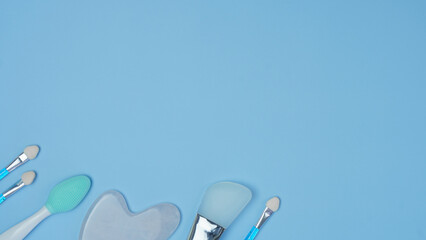 cosmetic accessories on a blue background. makeup brushes, sponges for applying decorative...