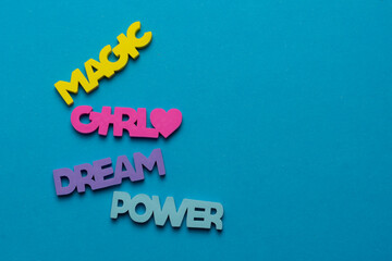 Color inspirational words: girl, power, magic, dream on a bright blue background