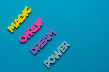 Color inspirational words: girl, power, magic, dream on a bright blue background