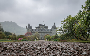 Fototapeta na wymiar Exterior of the Inveraray Castle in scotland with blooming plant in the castle garden park 