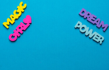 Color inspirational words: girl, power, magic, dream on a bright blue background
