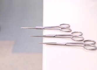 Small sharp surgical scissors placed on table unattended.Image isolated on blurred background .
