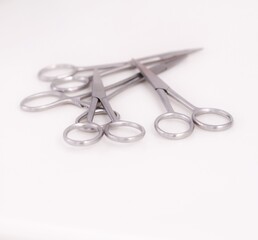Bunch of surgical scissors on a white background ,shallow depth of field image.