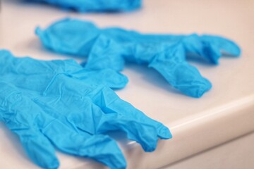 A pair of used blue colour gloves not disposed properly according to infection control practices