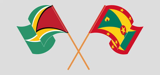 Crossed and waving flags of Guyana and Grenada