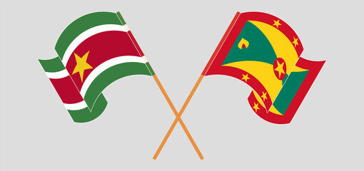 Crossed and waving flags of Suriname and Grenada