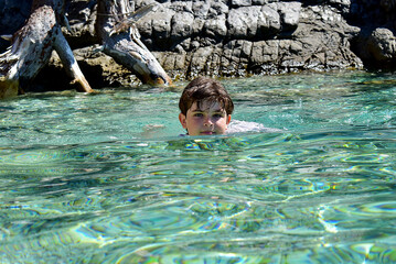 child swimming in the sea