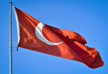 turkish flag against blue sky