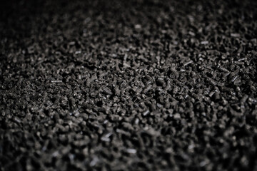 Black bio fuel pellets, close up view, selective focus