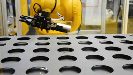 Robotic sorting system. Media. Gripper on universal robot is sorting details in smart warehouse