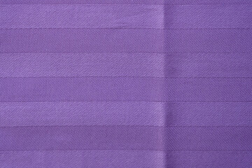 Fototapeta premium Soft pastel satin with jacquard weave. Dense purple fabric texture closeup. Natural cotton bedding. Bed sheet background.
