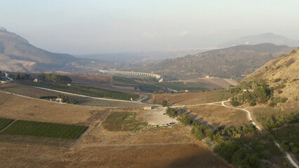 Top view or aerial shot of fresh green and yellow fields. Action. Top view of agricultural fields and mountains