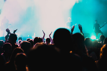 Obraz premium cheering crowd with raised hands at concert - music festival