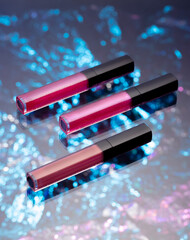 Liquid lipstick of different colors lies on an unusual background
