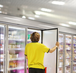 Fototapeta na wymiar Man choosing frozen food from a supermarket freezer 