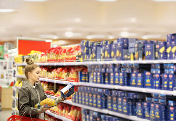 Woman choosing a dairy products at supermarket