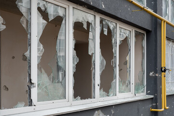 Aftermath bombed building window shatter glass damage building destruction Ukraine war Russia...