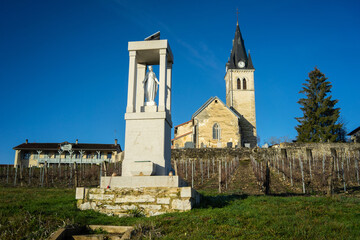 The Saint Didier church, the statue of the virgin mary and the old town hall and school (mairie, école ) in Rignat, department of Ain, France.