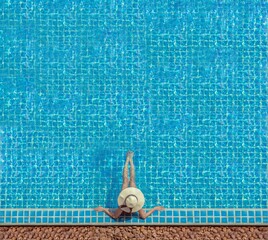 Cute girl is relaxing in the pool.