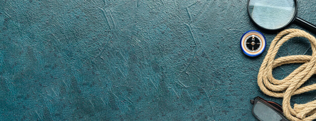 Magnifier, compass, rope and eyeglasses on grey background with space for text. Travel concept © Pixel-Shot