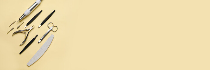 Manicure instruments on beige background with space for text