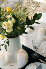 Stylish table setting for wedding celebration with bouquet of flowers