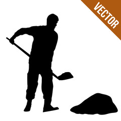 Silhouette of a man digging with a shovel