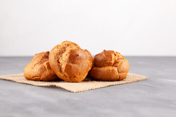 Profiteroles. Golden french buns filled cream, close-up. Homemade baking