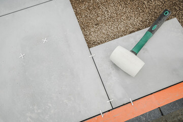 Soft Gum Made Hammer Laying on Concrete Patio Floor Blocks