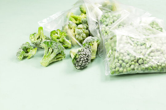 Frozen vegetables, close-up. Green peas and broccoli in transparent bags. proper defrosting of vegetables