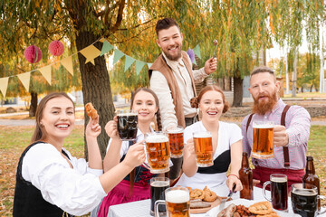People with beer celebrating Octoberfest outdoors