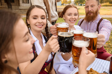 People with beer celebrating Octoberfest outdoors
