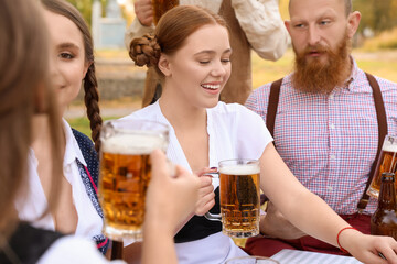 People with beer celebrating Octoberfest outdoors