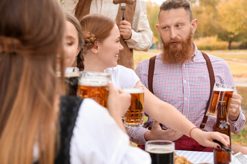 People with beer celebrating Octoberfest outdoors