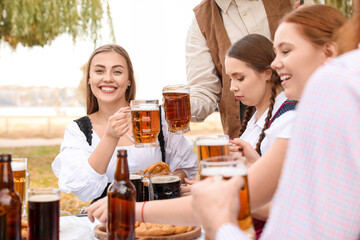 People with beer celebrating Octoberfest outdoors