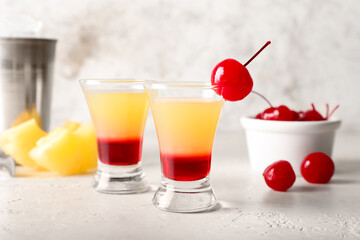 Tasty Pineapple Upside Down Cake Shots on light background