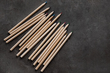 Colorful pencils on dark grunge background