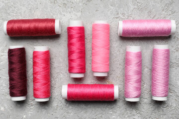 Sewing threads on grey background