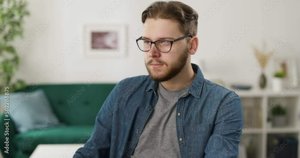 Poster qualified it-specialist in eyeglasses using stationary computer for coding at cozy apartment. caucas
