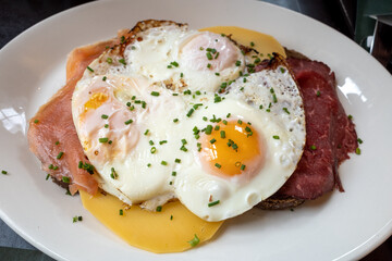 Uitsmijter, traditional dutch breakfast, lunch or bunch, fry egg with salmon, roast beef, cheese and sliced of bread. 
