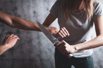 woman defending herself with a kitchen knife
