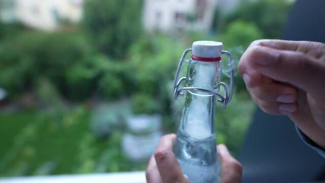 Opening glass bottle POP refreshment soda in slow motion