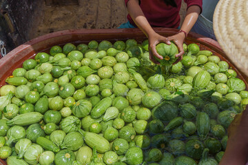 green courgettes in a plastic container before being packed