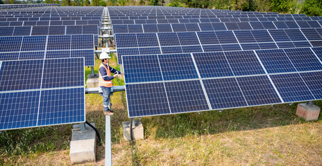 The solar farm(solar panel) with engineers check the operation of the system, Alternative energy to...