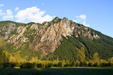 Mount Si rising above the farmalnd in North Bend Washington with the slopes covered in everegreen trees