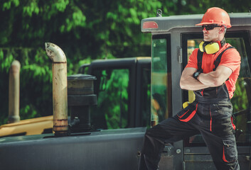 Professional Crawler Operator Next to Heavy Equipment © Tomasz Zajda